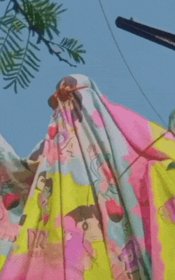 a blanket with cartoon characters on it is hanging on a pole