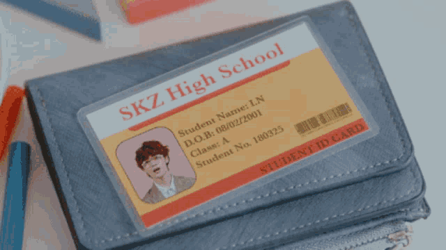 a student id card from skz high school sits on a wallet