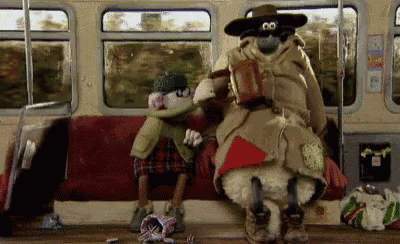 a man and a sheep are sitting on a train .