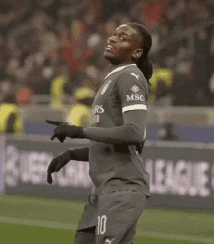 a soccer player wearing a fly better shirt is dancing on the field