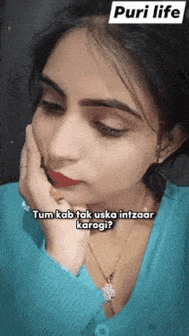 a woman wearing a blue sweater and a necklace says tum kab tak uska intzaar karogi ?