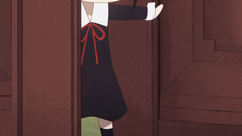a cartoon girl in a black dress with a red bow