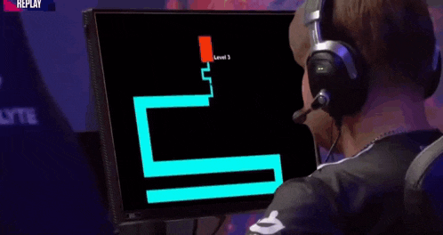 a man wearing headphones is looking at a scary face on a computer monitor