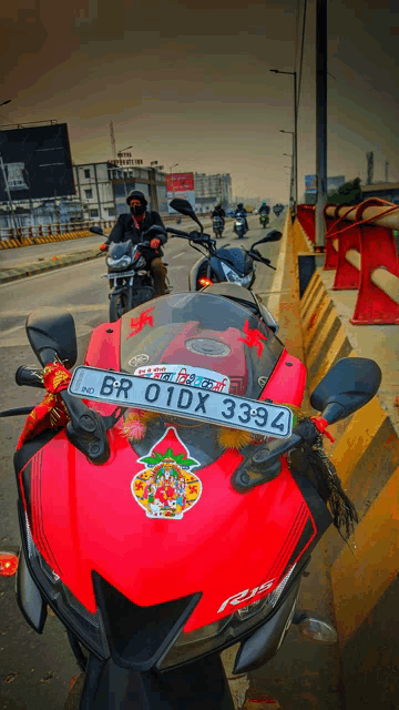 a red motorcycle with a license plate that says br 01dx 3393