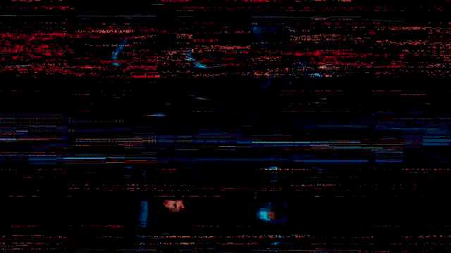 a man is holding a red light sword in a dark room