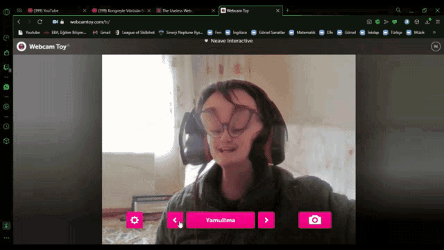 a computer screen shows a woman wearing glasses and headphones and the words webcam toy