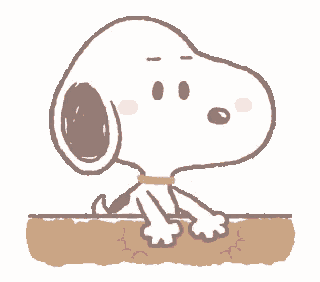 snoopy is sitting at a table with his hand to his mouth .