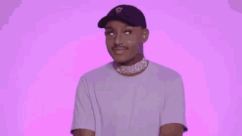 a young man wearing a hat and a choker is making a funny face .