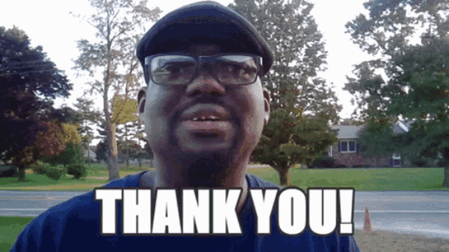 a man wearing glasses and a hat says thank you in white letters