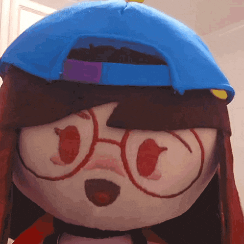 a stuffed animal wearing a blue hat and glasses