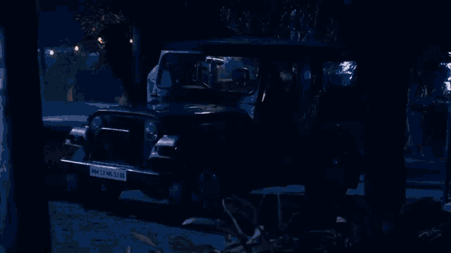 a man and woman are driving a car at night
