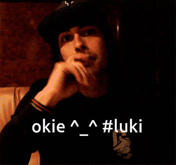 a man wearing a hat and a black shirt with the words okie and #luki
