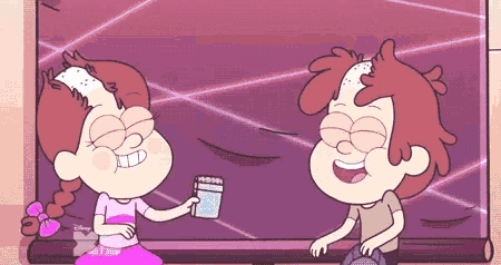 a boy and a girl are sitting in front of a television . the girl is holding a glass of water .