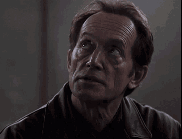 a close up of a man 's face with his eyes closed