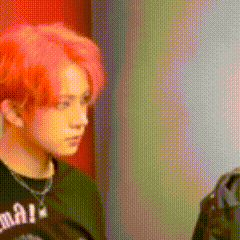 a man with red hair is wearing a black shirt .