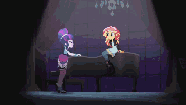 a couple of girls are dancing on a stage in a dark room