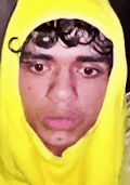 a close up of a man wearing a yellow hoodie .