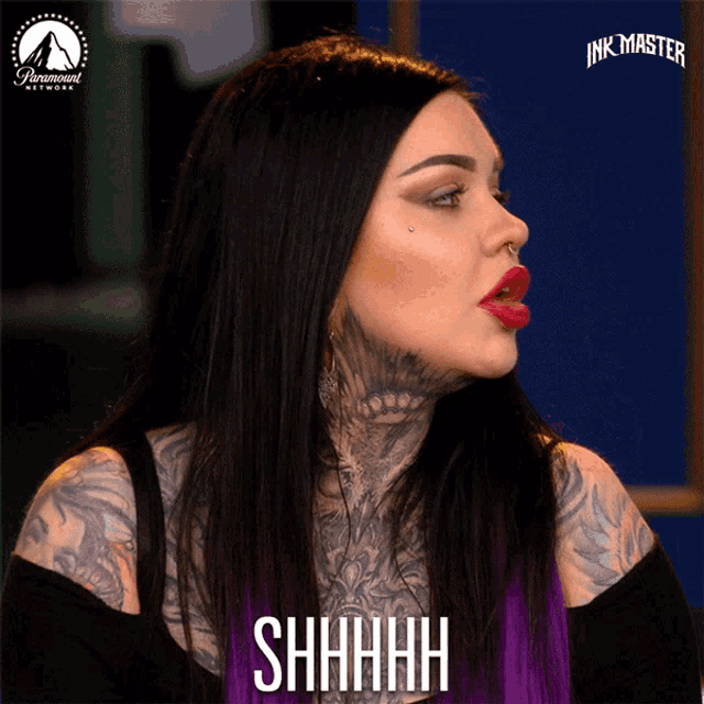 a woman with tattoos on her face says shhhh on a screen