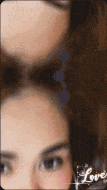 a close up of a woman 's face with the word love on the bottom right