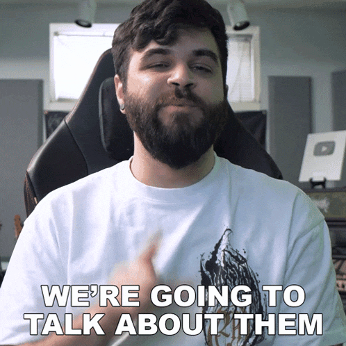 a man with a beard wearing a white shirt says we 're going to talk about them