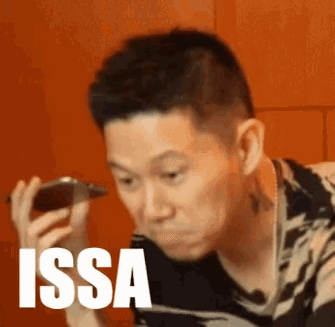 a man is holding a cell phone to his ear and the word issa is on the bottom