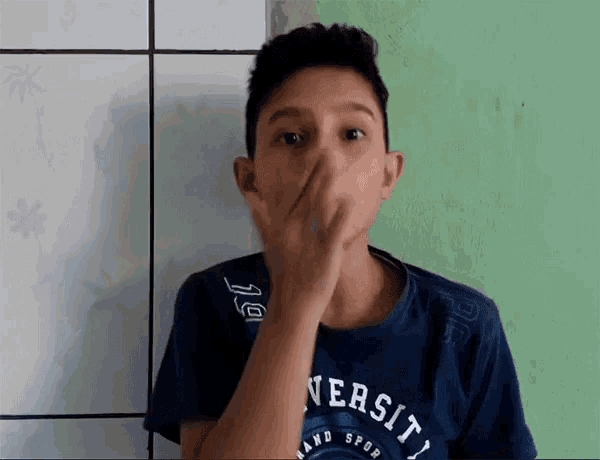 a boy wearing a blue shirt that says university on it