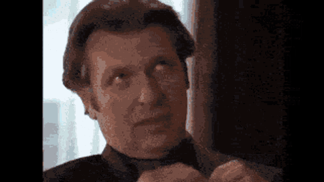 a close up of a man 's face with a blurred background .