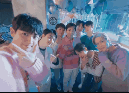 a group of young men are posing for a picture and one of them is wearing a pink shirt that says emirates