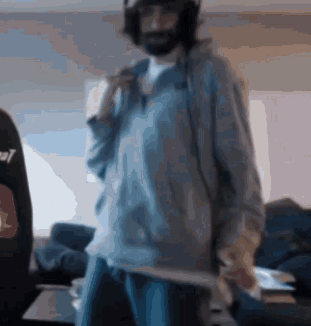 a blurry picture of a man wearing headphones and a sweatshirt that says cat on it
