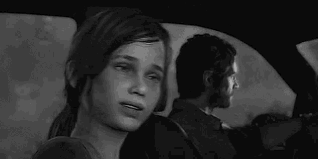 a black and white photo of a woman covering her mouth with a person 's arm .