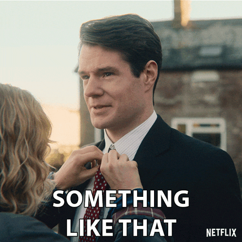 a man in a suit and tie is being helped by a woman who says something like that on the bottom