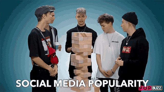 a group of young men standing around a stack of wooden blocks with the words social media popularity pop buzz below them
