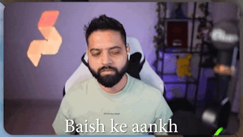 a man with a beard is sitting in a chair with his eyes closed and the words baish ke aankh on the screen .