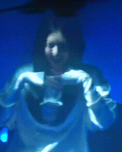 a blurry picture of a person in a white shirt against a blue background