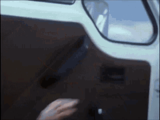 a close up of a person 's hand opening a car door