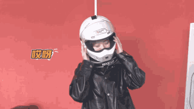 a woman wearing a white motorcycle helmet that says no leading riding