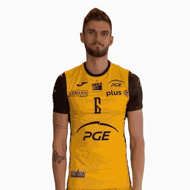 a man is wearing a yellow pge shirt