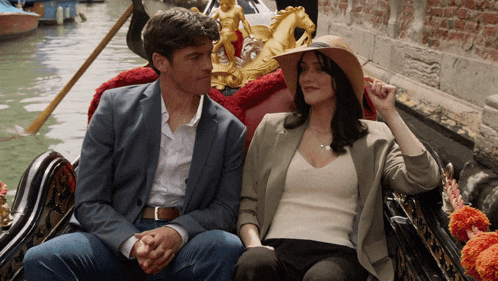 a man and woman are sitting in a gondola