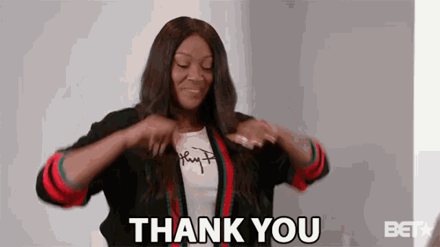 a woman is wearing a shirt that says ' hey ' on it and a jacket that says ' thank you '