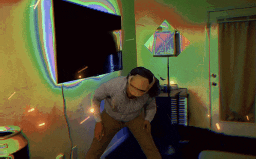a man is dancing in front of a television