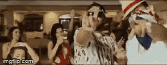 a group of people are dancing in a room with a watermark that says imgflip.com .