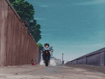 a man is riding a scooter down a street