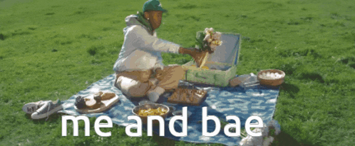 a man is sitting on a blanket in the grass with the words me and bae written below him