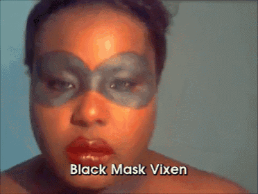 a woman wearing a black mask with the words " black mask vixen " above her