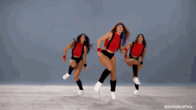 three women are dancing in front of a blue background with the hashtag #therefaceplace