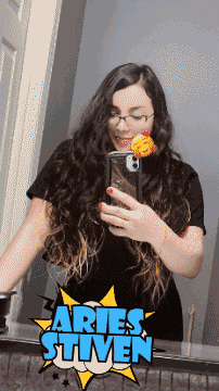 a woman taking a selfie in front of a mirror with the words aries steven on the bottom
