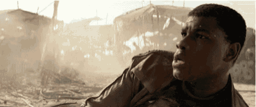 a man is standing in front of a destroyed building and looking at something .