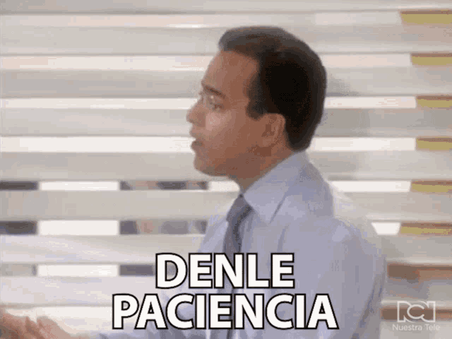 a man in a blue shirt and tie says denle paciencia in black letters