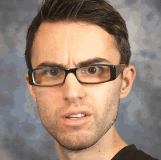 a man wearing glasses is making a funny face .