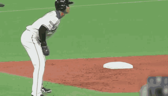 a baseball game is being played with jaccs aeon and nitori advertisements